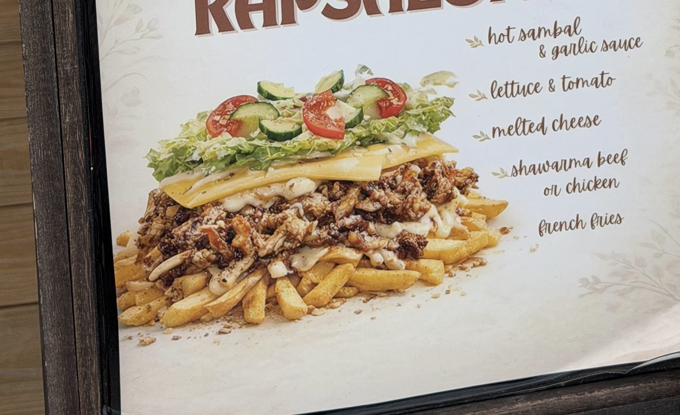 Luna's Dutch kapsalon: fries topped with shawarma, melted cheese and salad